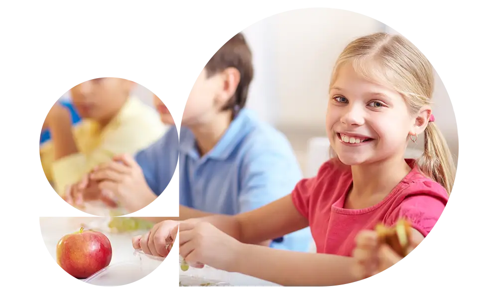 Fotografia di una bambina in classe che guarda sorridente in camera