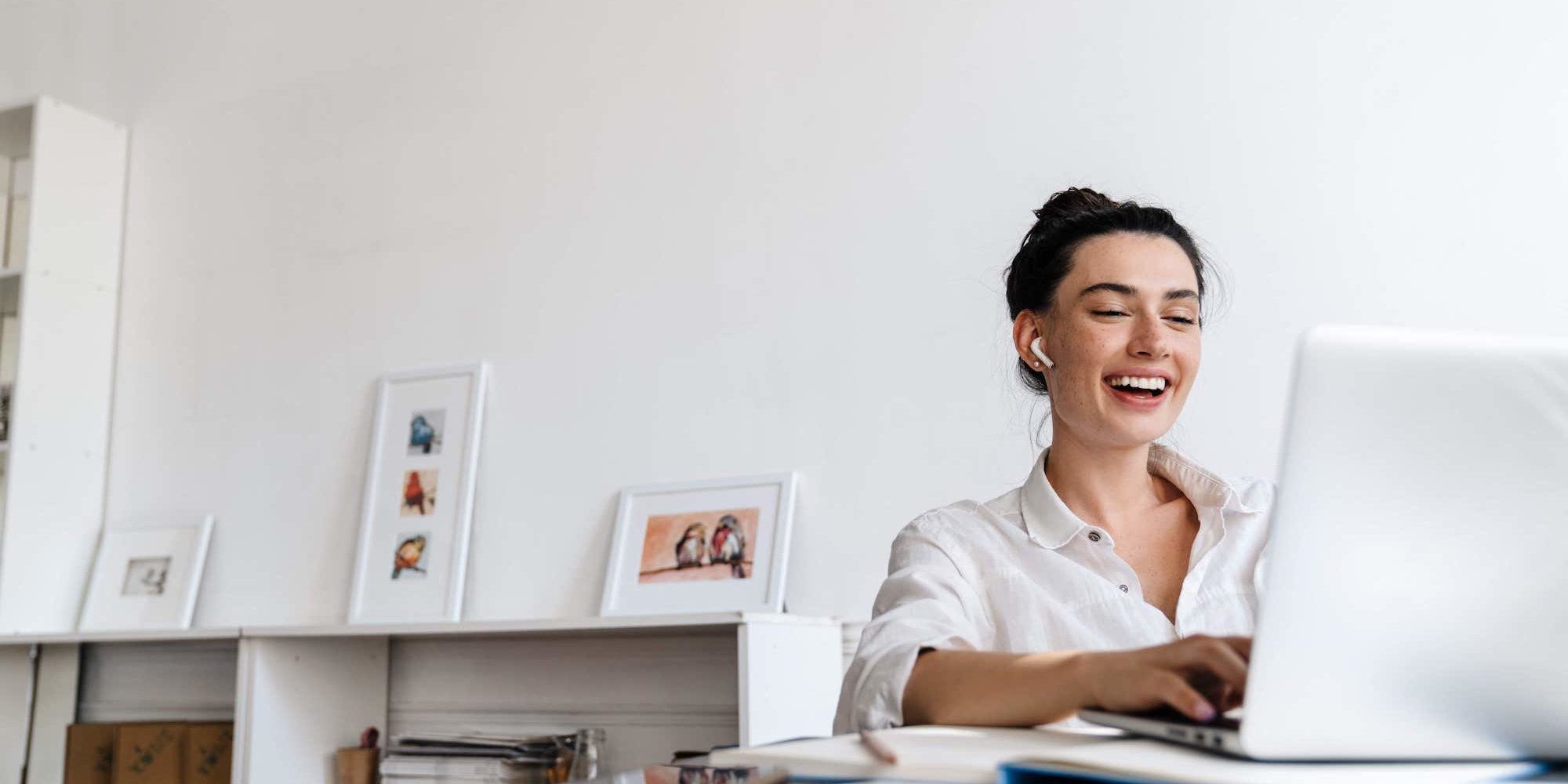 Fotografia di una insegnante che sorride mentre fa una videocall al suo computer portatile